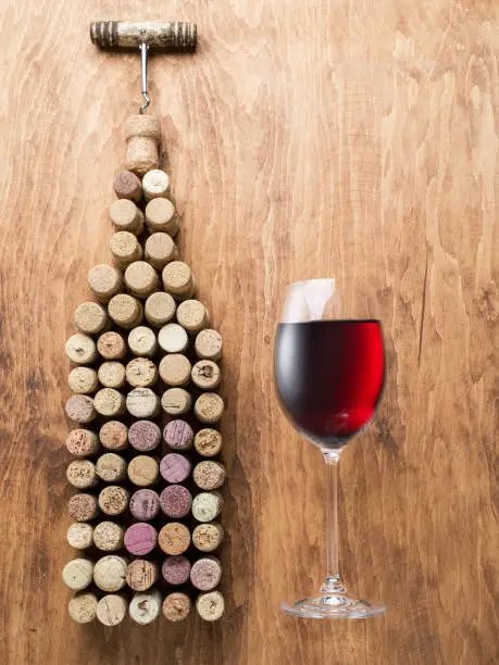 Photo of Wine corks in the shape of wine bottle on the wooden background.