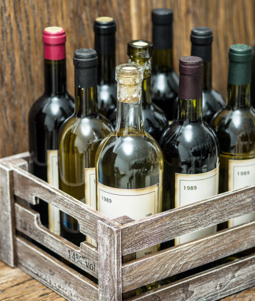 istock Old wine bottles in a wooden crate. 901469124