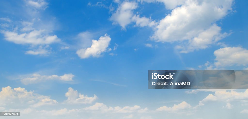 Light cumulus clouds in the blue sky. Wide photo. Sky Stock Photo