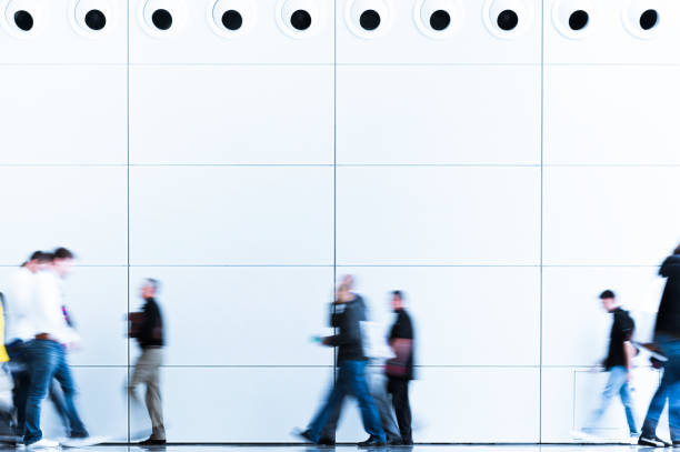istock blurred trade fair visitors in a modern hall 901477936