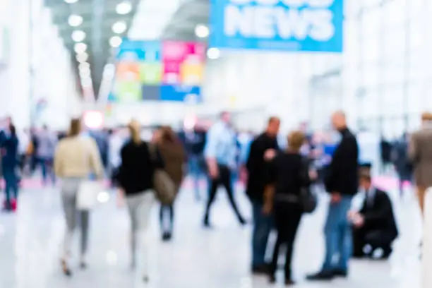 blurred business people walking in a modern hall