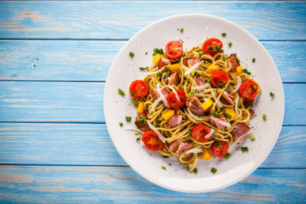 Spaghetti with vegetables and bacon
