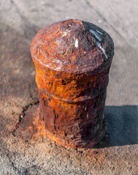 istock Very old iron bollard on concrete marine dock for boat 901481658