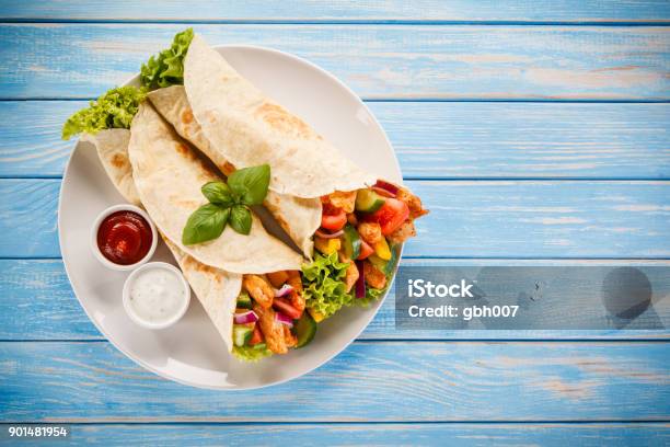 Tortilla Wrap With Meat And Vegetables Stock Photo - Download Image Now - Wrap Sandwich, Chicken Meat, Plate