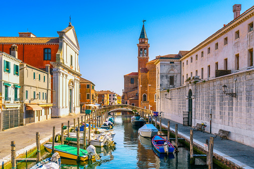 Chioggia town in venetian lagoon, water canal and church. Veneto, Italy, Europe