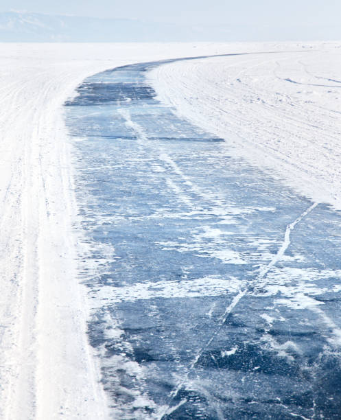 Baikal Lake in winter. Ice road on frozen lake Baikal. Winter tourism stock photo