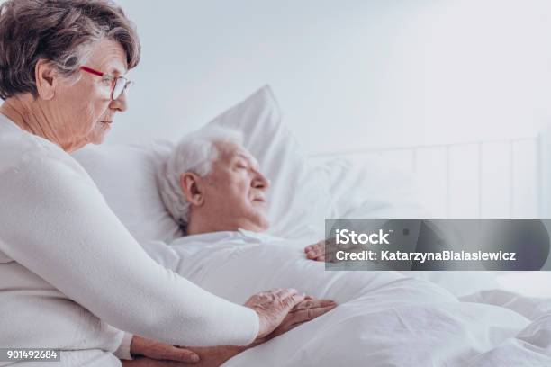Elderly Woman Supporting Sick Husband Stock Photo - Download Image Now - Senior Adult, Illness, Domestic Life