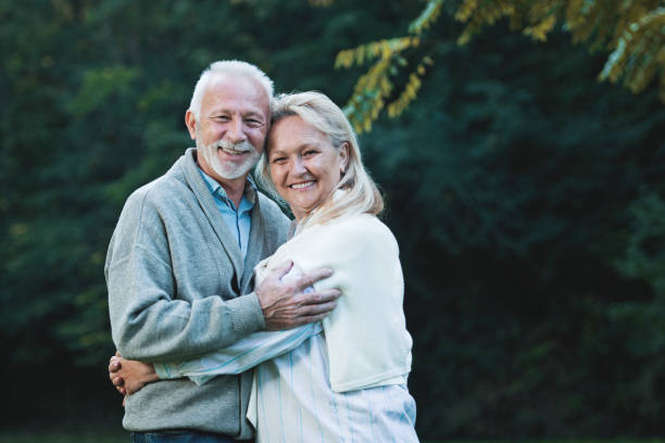 istock Happy senior couple smiling outdoors in nature 901493268