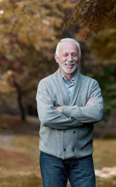 istock Elderly man smiling outdoors in nature 901493508