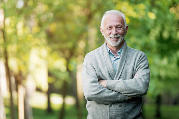 istock Elderly man smiling outdoors in nature 901493558