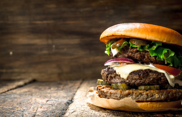 istock Big burger with beef, tomatoes and greens. 901493804
