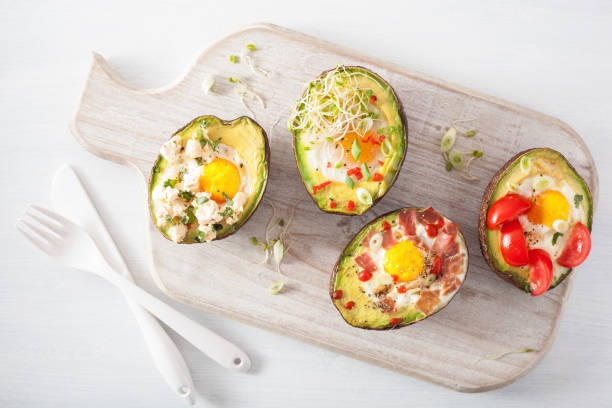 istock eggs baked in avocado with bacon, cheese, tomato and alfalfa sprouts 901494504