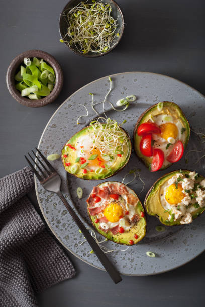 istock eggs baked in avocado with bacon, cheese, tomato and alfalfa sprouts 901496734
