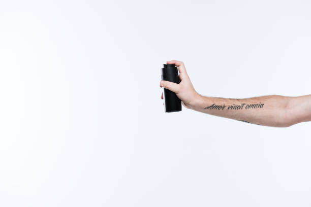 istock tattoed hand with deodorant spray, isolated on white 901497414