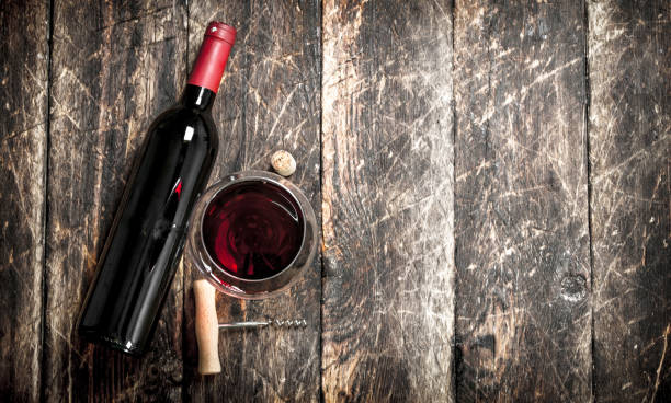 istock bottle of red wine with a corkscrew. 901497424