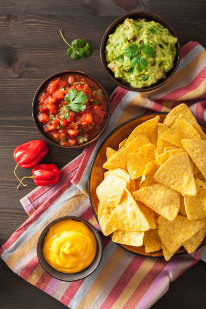 istock mexican nachos tortilla chips with guacamole, salsa and cheese dip 901500438