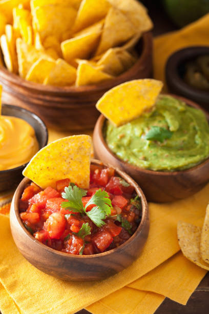 istock mexican nachos tortilla chips with guacamole, salsa and cheese dip 901500612