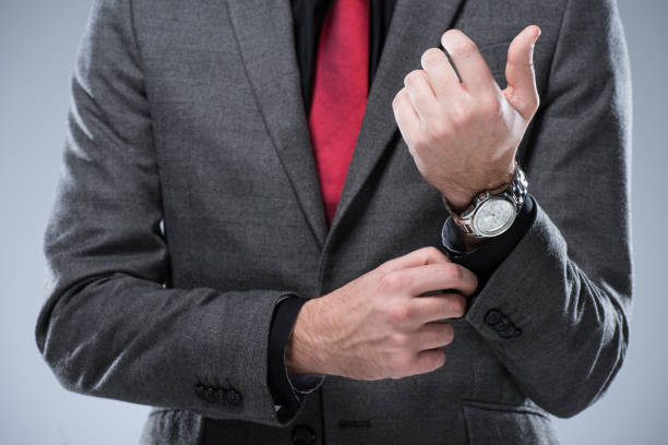 istock businessman in formal suit adjusting button on sleeve 901500766