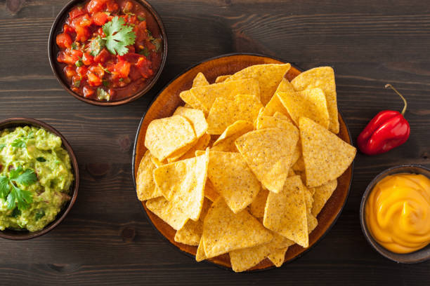 istock mexican nachos tortilla chips with guacamole, salsa and cheese dip 901500782