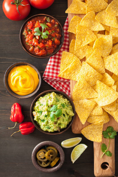 istock mexican nachos tortilla chips with guacamole, salsa and cheese dip 901501274