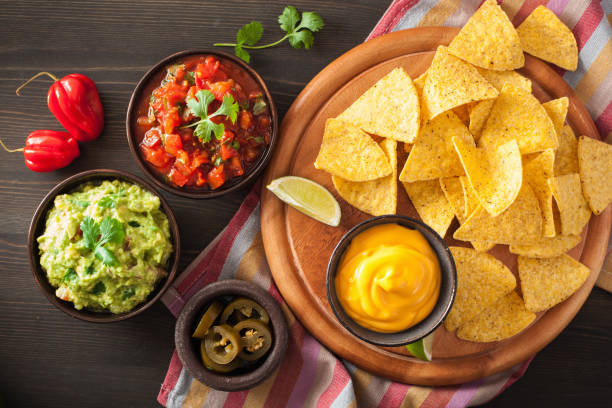 istock mexican nachos tortilla chips with guacamole, salsa and cheese dip 901501944
