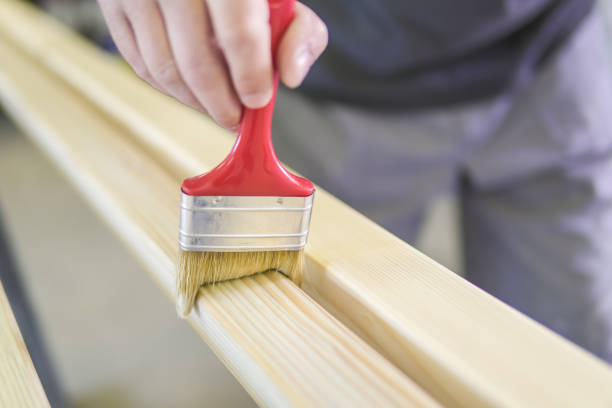 istock Young man painting an old wooden table 901505078