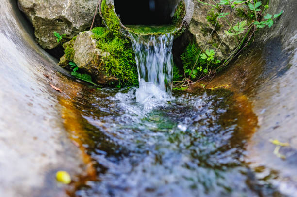 flowing water spring pipe - groundwater imagens e fotografias de stock