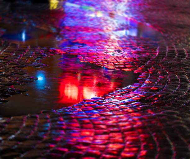 istock Streets after rain with reflections of light on wet roadway 901506518