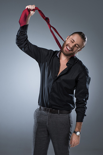 Man In Black Shirt Holding Red Tie Around His Neck Stock Photo - Download  Image Now - Istock