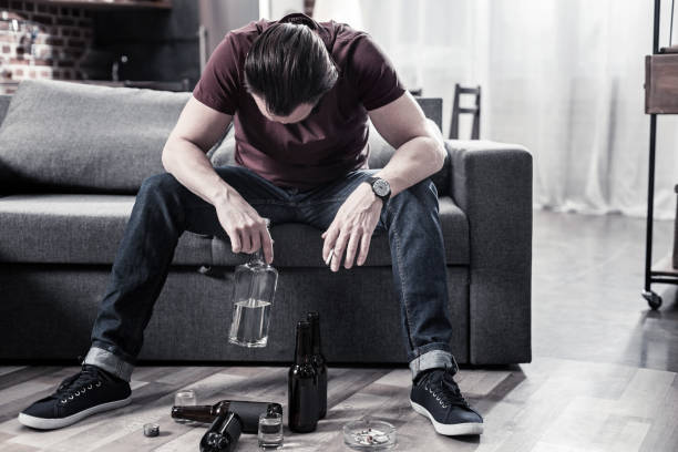 istock Sad depressed man holding a bottle 901506628