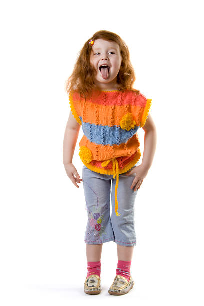 Little girl pokes out her tongue stock photo