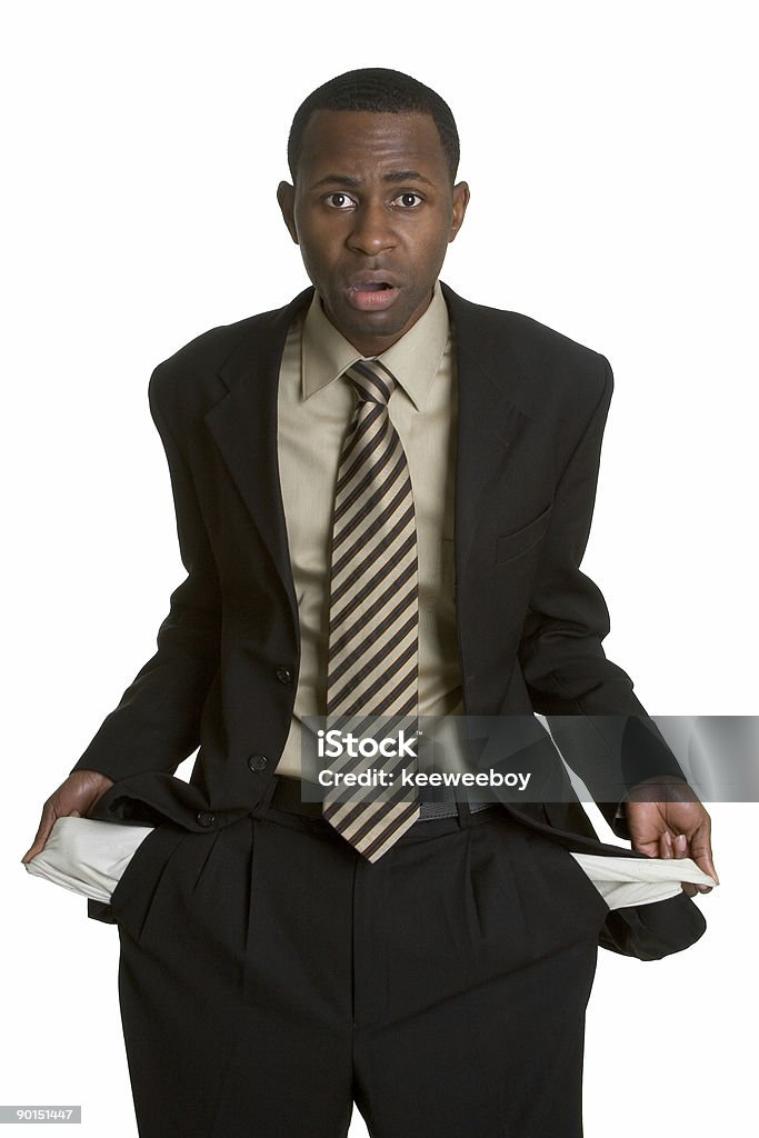 An African American man holding out his empty pockets African american businessman with empty pockets Currency Stock Photo