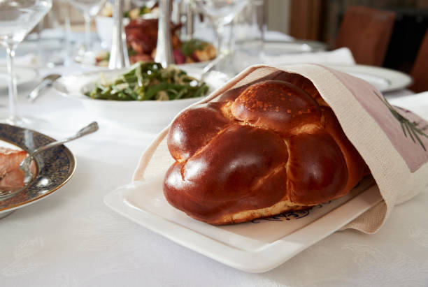 istock Challah bread on a table set for Jewish Shabbat, close up 901526150