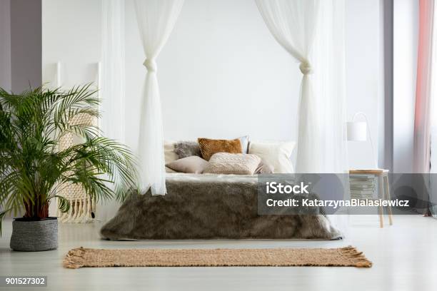 Bohemian Bedroom With Earth Colors Stock Photo - Download Image Now - Four-Poster Bed, Rug, Jute