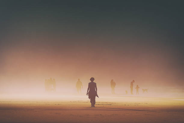 istock lonely woman walking on beach 901527324