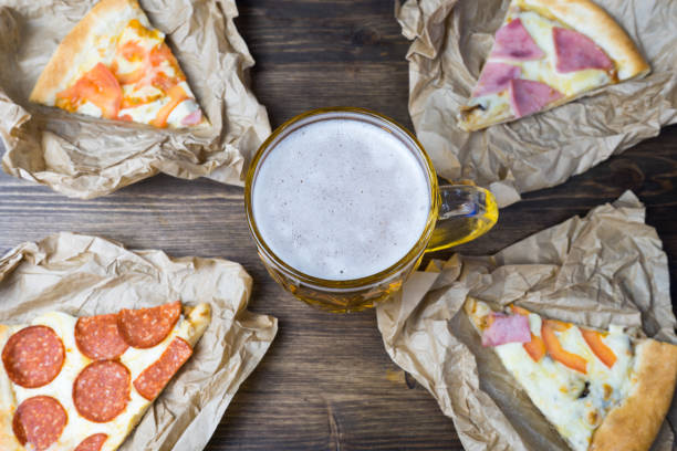 istock Light beer in glass and fragrant Italian pizza. 901530596