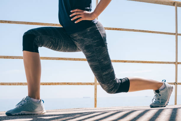 Athletic young woman doing lunges