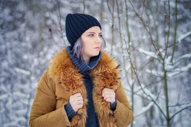 istock young beautiful girl posing in winter forest 901533282