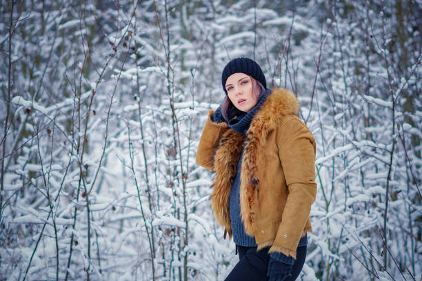 istock young beautiful girl posing in winter forest 901533750