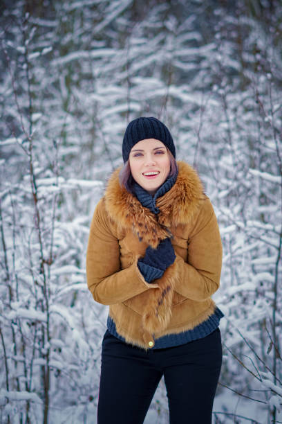 istock young beautiful girl posing in winter forest 901533780