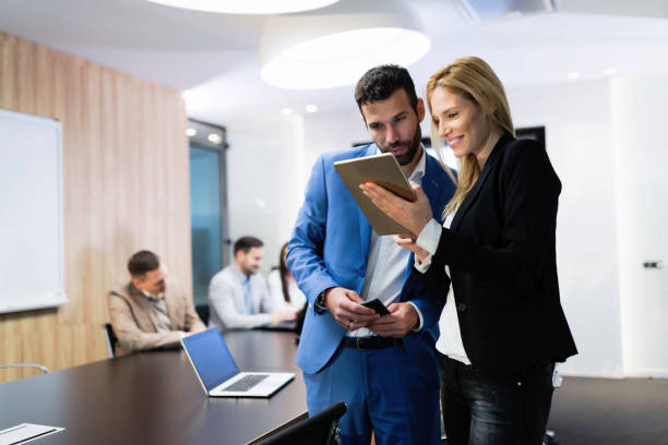 istock Attractive business couple using tablet in their company 901534110