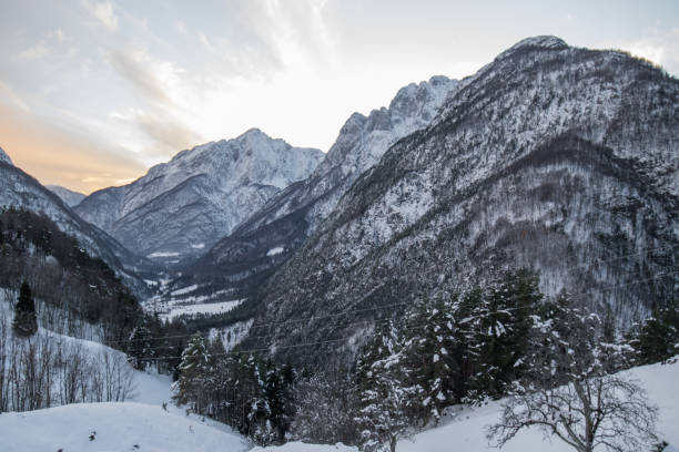 istock idyllic alpine snowy mountain view in sunset sky, Slovenia 901535006