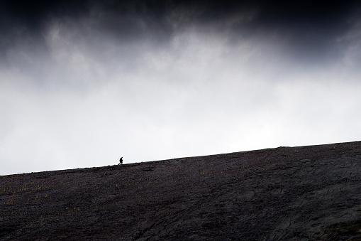 A man climbs up the hill