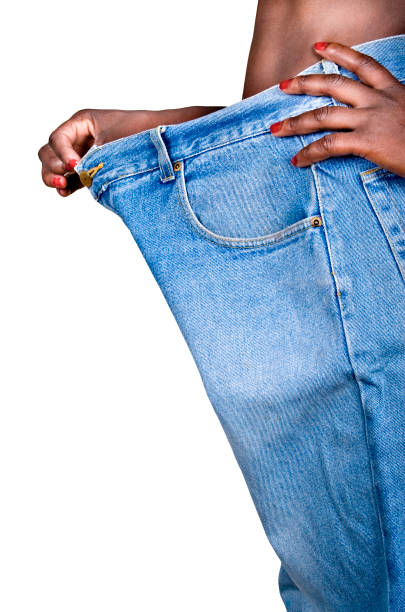 African woman weight loss African American woman with huge trousers, weight loss concept slenderman fictional character stock pictures, royalty-free photos & images