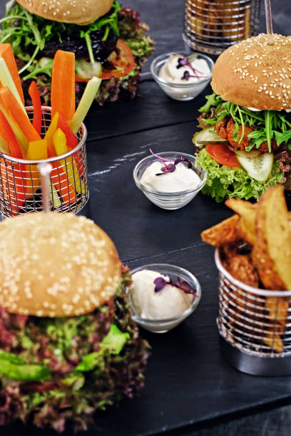 istock Burger, fries with salad on a table. 901537980