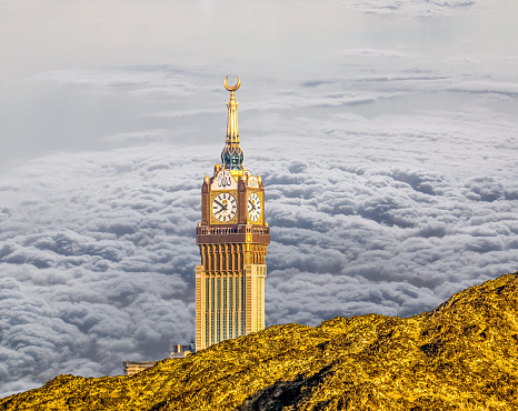 Scenic view of Makkah Tower, (Royal Clock Tower Mecca) and dry mountains of holy city Saudi Arabia