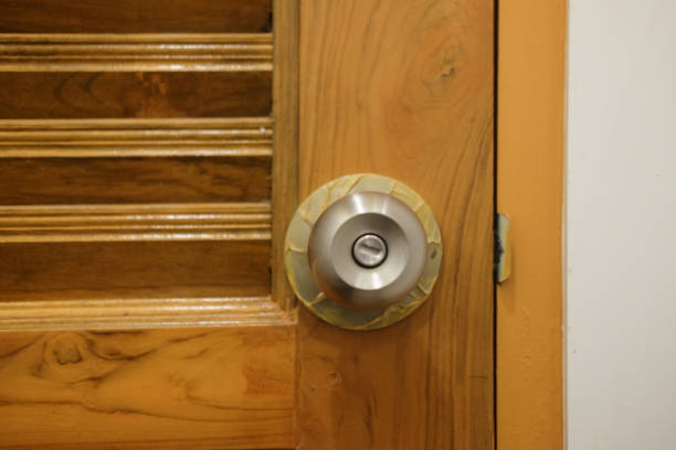 istock Knob locks on brown wooden door. 901539614