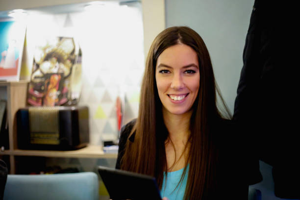 istock Handsome woman using digital tablet in a cafe 901542914
