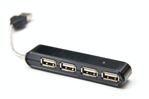 Black USB multiformat memory card reader on a grey background