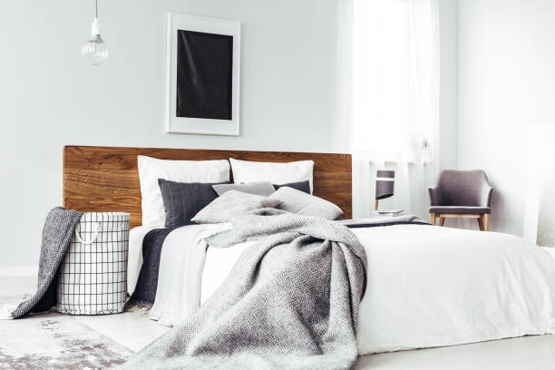 istock Black poster above wooden bed 901545226